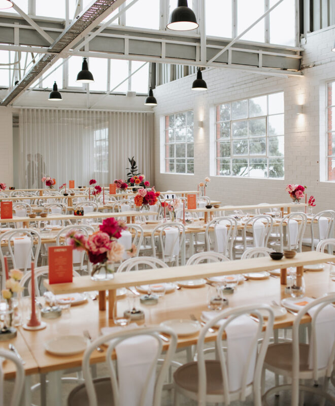 The stunning reception space at The Button Factory, a luxury Melbourne event venue, is perfectly styled by The Goodsmiths with bespoke event styling and vibrant florals by Anatomy of Flowers, creating a modern and memorable wedding reception.