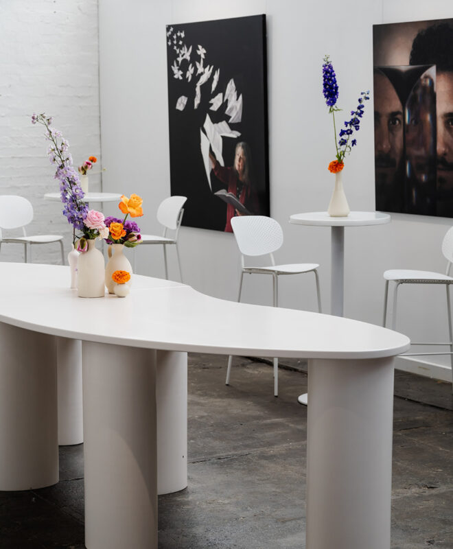 The Button Factory's gallery space is ideal for greeting guests, beautifully adorned with florals by Anatomy of Flowers, setting the perfect tone for a stylish event in Melbourne.