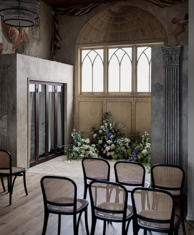 Beautiful wedding ceremony setup at Chapel 1885, showcasing stunning chapel windows in the background, with elegant floral arrangements by Anatomy of Flowers, creating a romantic and timeless atmosphere for a Melbourne wedding.