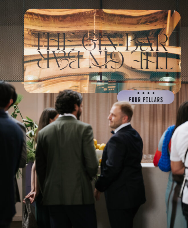 Guest enjoying a custom gin bar at The Button Factory by Nudo, designed by The Goodsmiths. Unique refreshment station at a beautifully styled event, blending modern design with industrial character.