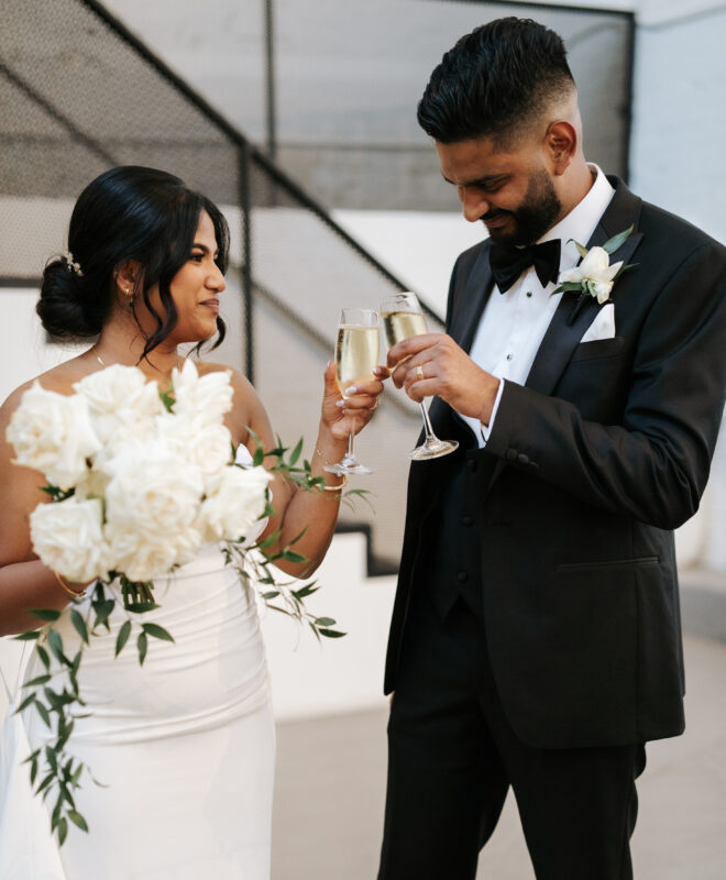 Newlyweds celebrating at The Wool Mill, an elegant warehouse-style wedding venue in Melbourne, with a stunning white bouquet by Anatomy of Flowers.